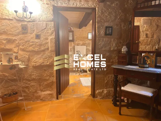 a room with a wooden floor and a wall with a mirror