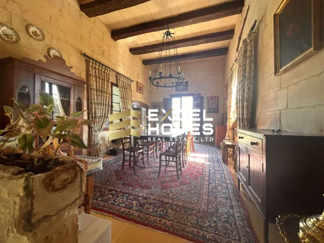a living room with a table and chairs