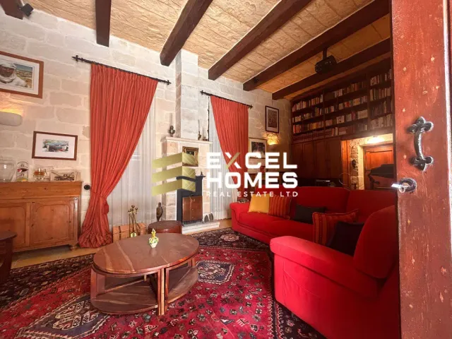 a living room with a red couch and a red rug