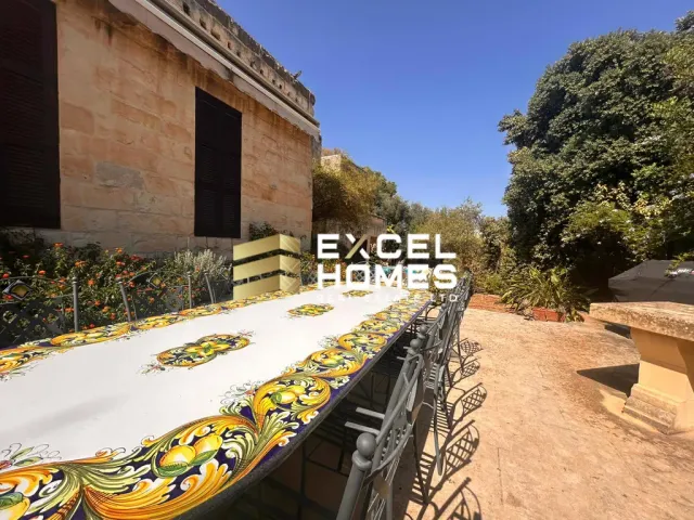 a wooden bench sitting in front of a large building