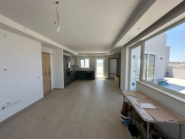 a room with a large window and a large wooden floor