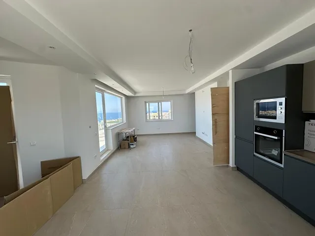 a kitchen with a large window and a large refrigerator