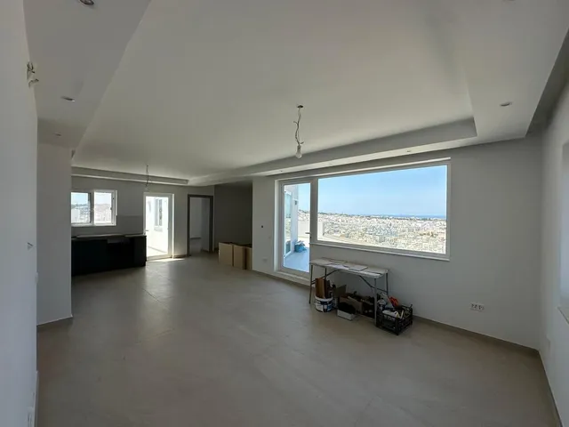 a room with a large window and a large bed