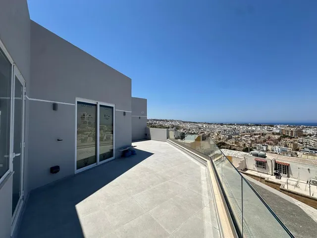 a large building with a balcony overlooking a city
