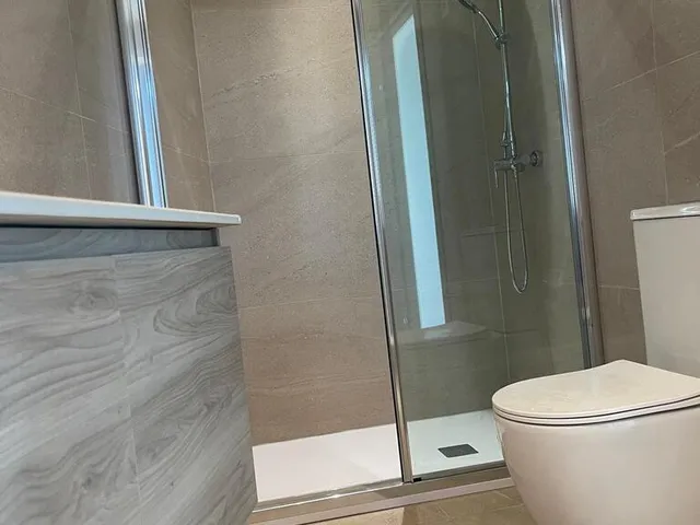 a bathroom with a toilet and a shower