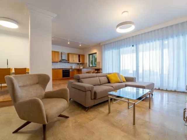 a living room with a couch, chair, and a television