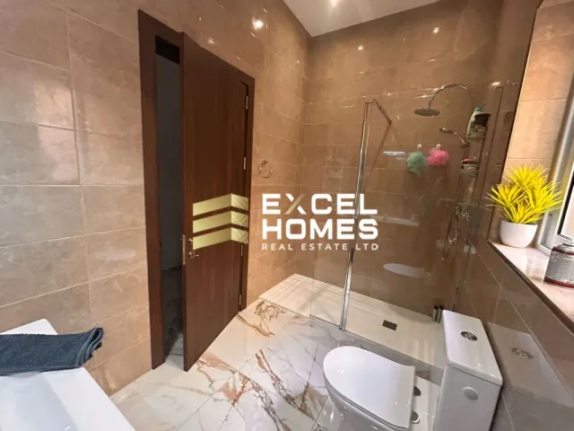 a bathroom with a toilet, sink, and mirror