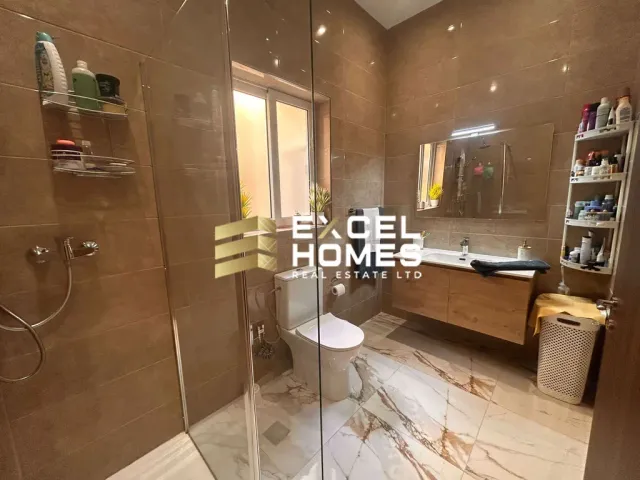 a bathroom with a toilet, sink, and shower