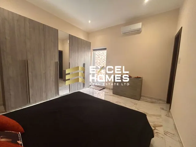 a room with a white couch and a black rug