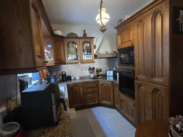 a kitchen with a stove, sink, and refrigerator