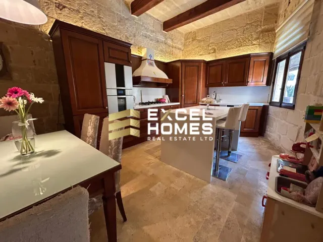 a kitchen with a table and chairs and a refrigerator