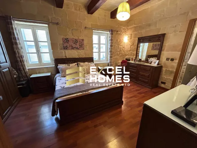 a living room with a large window and a bed