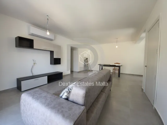 a hotel room with a bed, table, and a television