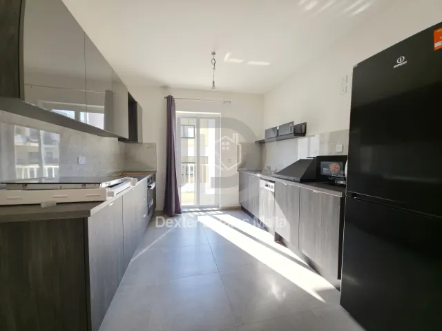 a kitchen with a stove, refrigerator, sink and microwave