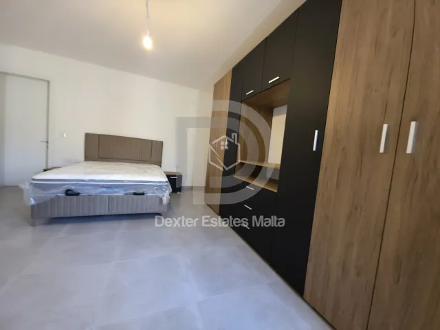 a bedroom with a bed and a desk