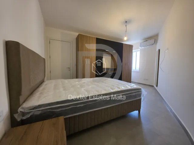 a bed in a room with a wall