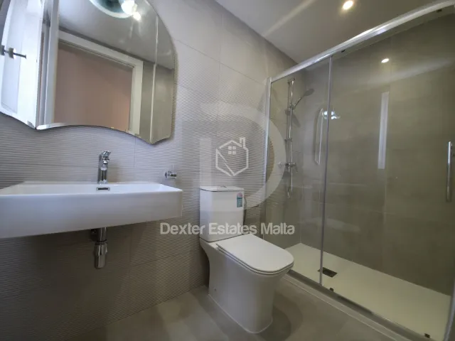 a bathroom with a sink, toilet and shower