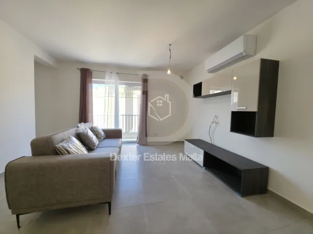 a living room with a couch, coffee table and a television