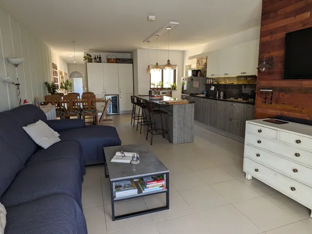 a living room with a couch, coffee table and a television