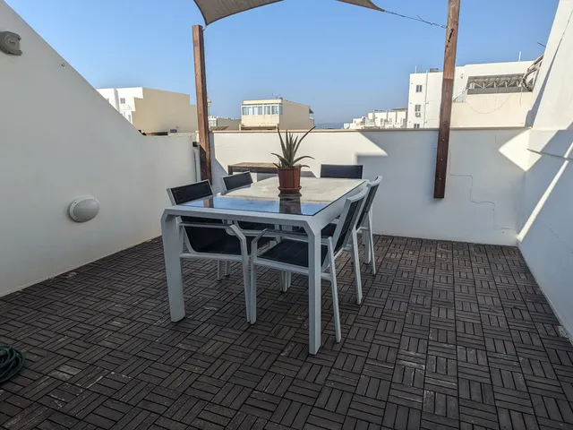 a table with a chair and a table cloth