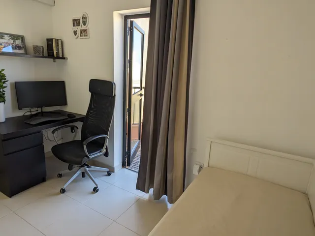 a small room with a desk and a chair