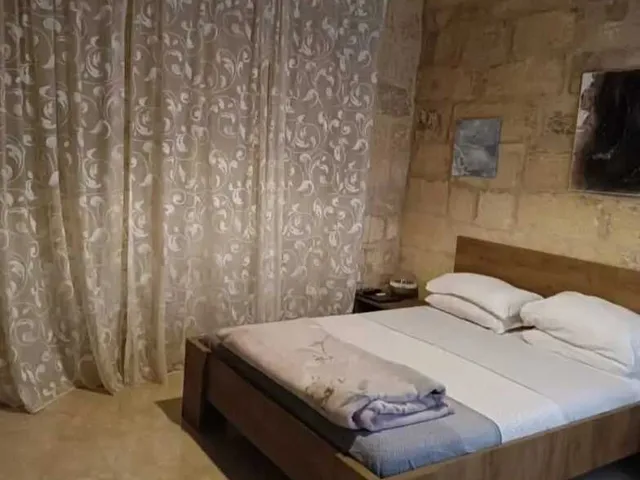 a bed with a white comforter and a white comforter
