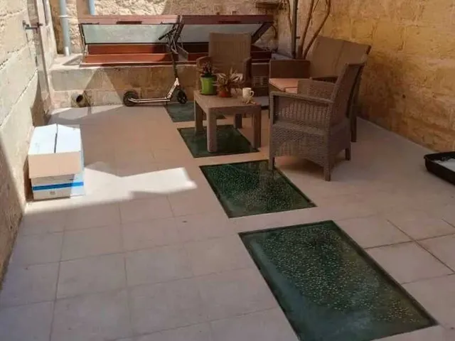 a living room with a table and chairs