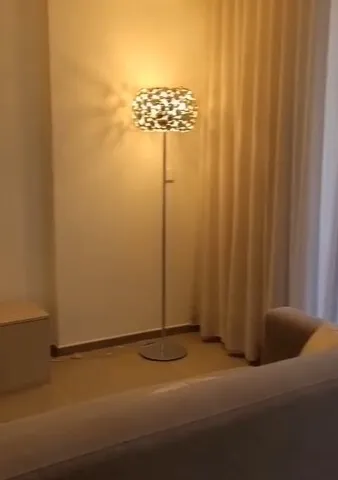 a lamp is on in a dimly lit room