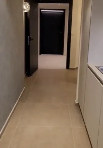 a kitchen with a door open and a white refrigerator