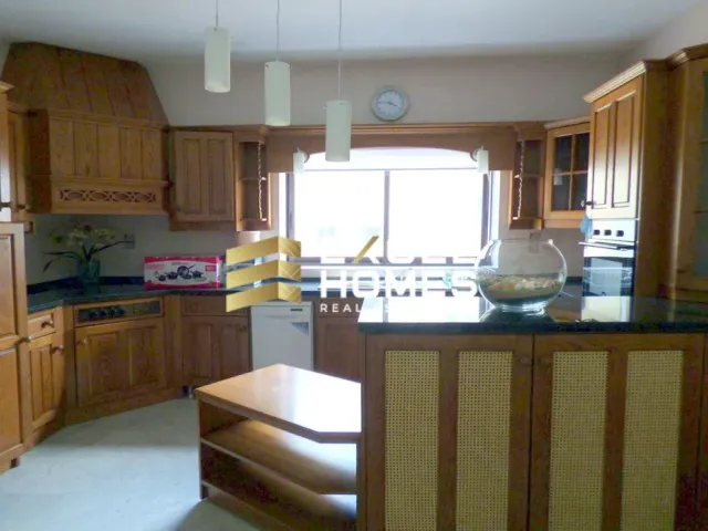 a kitchen with a sink, stove, and refrigerator