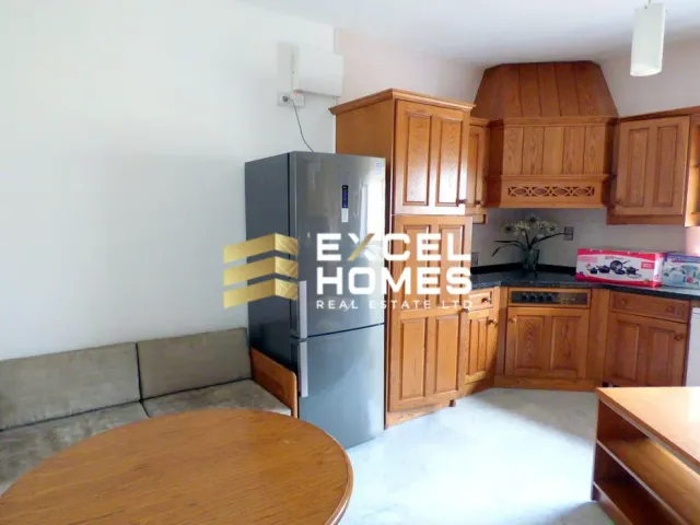 a kitchen with a refrigerator, stove, sink and a table