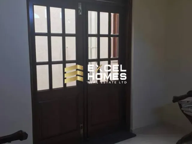 a room with a window and a bed with a basket