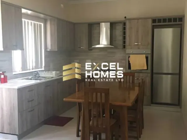 a kitchen with a refrigerator, stove, sink and a table