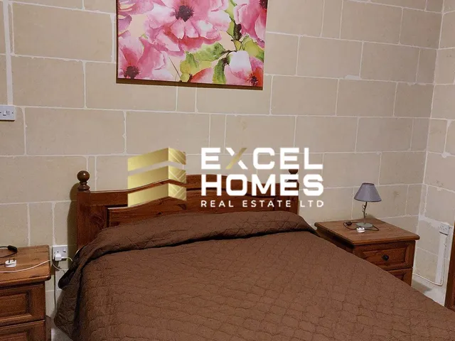 a bed with a white bedspread and a black and white bedspread