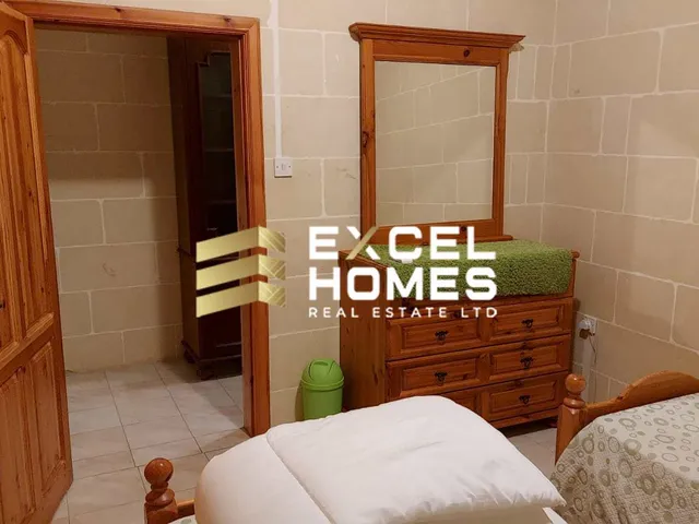 a bedroom with a bed, a dresser and a mirror